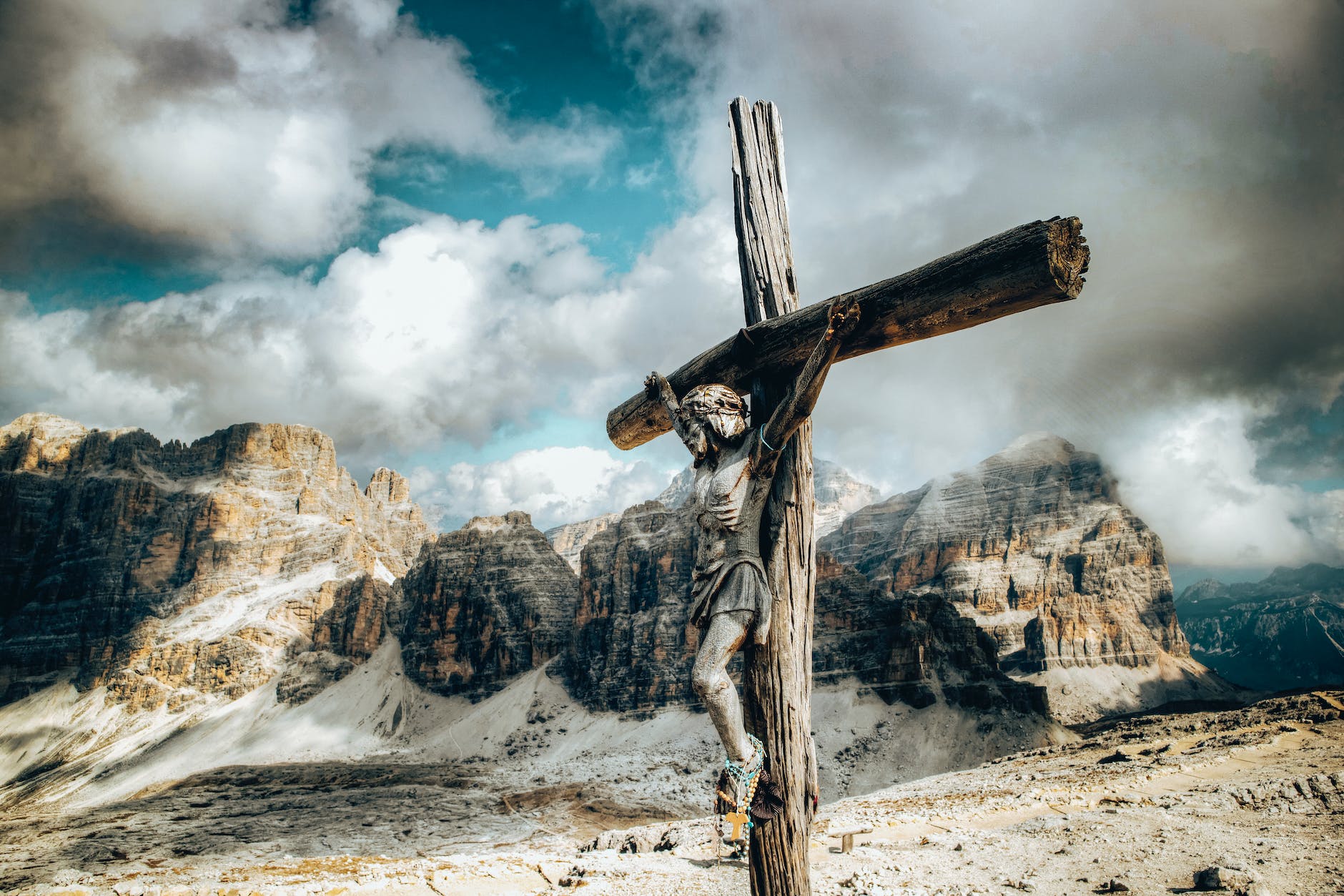 a wooden crucifix against the rock mountains