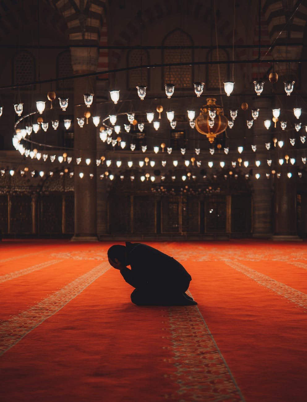 man praying in mosque