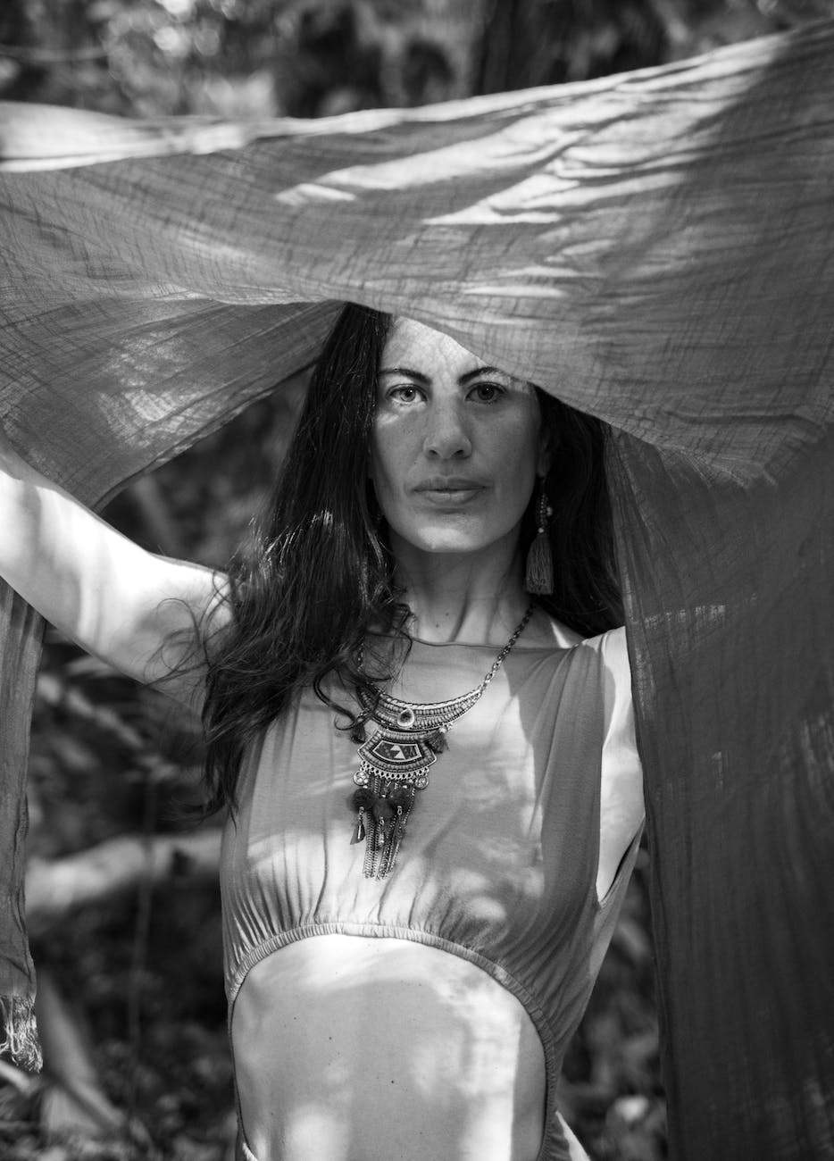 brunette woman in top with necklace